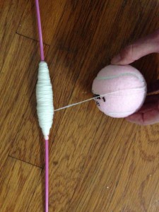 Removing the singles from the quill onto a ball. I use an old knitting needle to hold the quill.