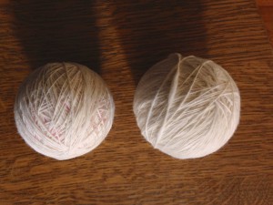 Partially full ball (left) and full ball of singles; I would add at least two more spindle’s worth of singles onto the partial ball before I create a plying ball. 