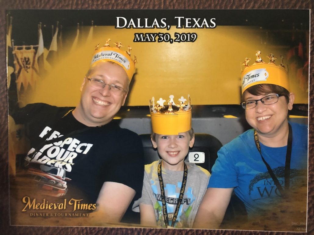 Karen's husband and son and Karen at Medieval Times